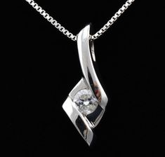 "Features * ITEM #: 4313p * METAL TYPE: 14 Karat White Gold * AVAILABLE IN: Rose Gold, Yellow Gold, White Gold * STONES USED: Diamonds * DIAMOND QTY: 1 * DIAMOND SHAPE: Round * DIAMOND CTW: .125carat * SETTING TYPE: channel set WEIGHT 1.5 gm LONG 17mm with bail Width 6.5mm * READY TO SHIP: in 3-5 Business Days FOR ADDITIONAL QUESTIONS ABOUT THIS PRODUCT: Please feel free to message us. We are quick to respond to all your inquiries. PLEASE choose as \"FAVORITE\" on the right so the item will be a Formal Diamond White Necklace With Polished Finish, Fine Jewelry White Diamond Necklace With Polished Finish, Fine Jewelry Diamond White Necklace With Polished Finish, White Diamond Necklace With Polished Finish, Elegant White Jewelry With Tension Setting, Wedding Silver Diamond Necklace With Polished Finish, White Diamond Jewelry With Polished Finish, Silver Diamond Necklace With Polished Finish For Wedding, Sterling Silver Diamond Necklace For Wedding