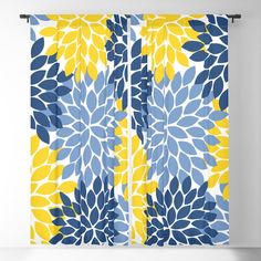 a blue and yellow floral curtain hanging on a wall