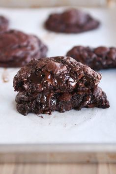 two chocolate cookies sitting on top of a baking sheet