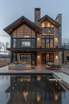 a large house with a pool in front of it and lots of windows on the side