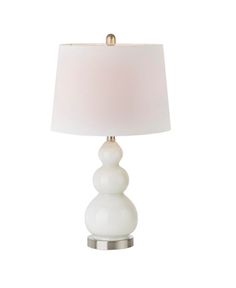 a white table lamp with a beige shade on the base and a silver metal base