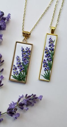 two necklaces with purple flowers on them