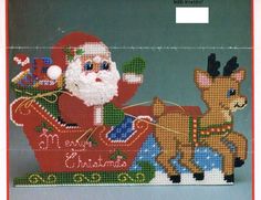 a cross stitch christmas card with santa riding in a sleigh and reindeers