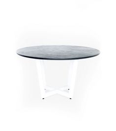 a round table with white legs and a black top