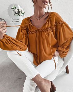 The EMES SHOP blouse is detailed with cute ruffle details. Features a tie neck. drop shoulder. solid color. and flowy fit. Pair it with palazzo pants and sunnies for a fantastic look.MATERIAL:100%Soft Poly MEASUREMENTS:Product Length 24"-26"in Small | Bust & Hem Width : 39"-41"in Medium| Bust & Hem Width : 41"-43"in Large| Bust & Hem Width : 43"-45"in X Large| Bust & Hem Width : 45"-47"in MEASUREMENTS:Product Length 60"-65"cm Small | Bust & Hem Width : 99"-104"cm Medium| Bust & Hem Width :104"-1 Solid Color Bohemian Blouse For Vacation, Chic Solid Color Blouse For Vacation, Chic Solid Color Blouse For Brunch, Chic Relaxed Fit Solid Color Blouse, Spring Vacation Blouse With Tie Sleeves, Versatile Blouse For Brunch, Beach Blouse With Tie Sleeves And Long Sleeves, Long Sleeve Tops With Tie Sleeves For Vacation, Billowy Summer Blouse For Brunch