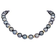 Elevate your jewelry collection with this exquisite Estate Tahitian Pearl Necklace, featuring 35 lustrous Tahitian pearls. Each pearl is elegantly separated by round 18k slider disks,  adorned with 128 natural round diamonds, approximately 3.20carat G-H color, and VS1-VS2 clarity adding a sparkling contrast to the deep, iridescent hues of the pearls. The necklace is secured with a robust magnetic gold clasp, ensuring both safety and ease of wear. Perfect for sophisticated gatherings or adding a touch of luxury to everyday attire, this timeless piece combines classic elegance with contemporary flair. Ideal for those seeking high-end, luxury pearl necklaces, it is a must-have for discerning collectors and fashion aficionados alike. Metal:18k  Excellent Condition Accompanied by a gemologist a Brown Pearl Necklace, South Sea Pearl Necklace, Three Strand Necklace, Tahitian Pearl Necklace, Tahitian Black Pearls, Gold Bead Necklace, Pearl Necklaces, Modern Necklaces, Tahitian Pearls