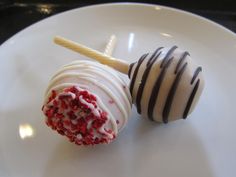 two desserts on a white plate with chocolate drizzled