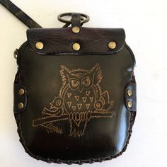 an owl is on the back of a black leather purse