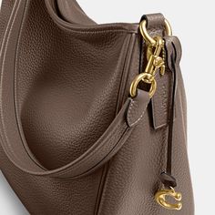 Deliberately slouchy with a sophisticated ease our Cary is a study in intentional laidback style. Crafted of buttery soft pebble leather with a silky sheen this surprisingly spacious bag has plenty of pockets to keep you organized. (Because even your most easygoing self should feel put-together.) | Coach Cary Shoulder Bag - Women's Purses - Brass/dark Stone Coach Cary Shoulder Bag, Fall Bags 2024, Coach Bags Handbags, Classy Handbags For Women, Cary Bag, Birken Bag, Fall Bags Handbags, Brown Coach Bag, Chef Bag