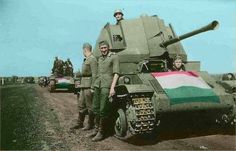 two men are standing next to a tank