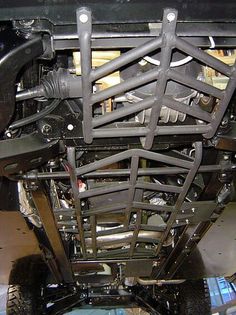 the front end of a vehicle that is being worked on with metal parts and tools