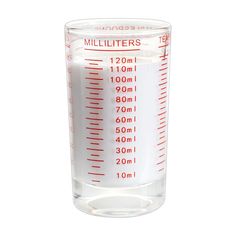 a measuring cup filled with liquid on top of a white surface