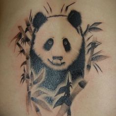 a panda bear with bamboo leaves on his chest