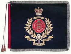 the royal coat of arms is displayed on a black and red blanket with tassels