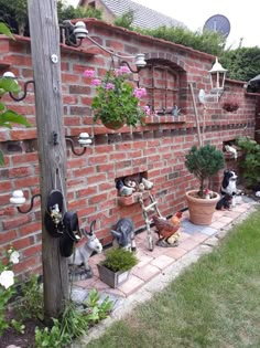 a brick wall with potted plants and fake animals on the outside, along with other garden items