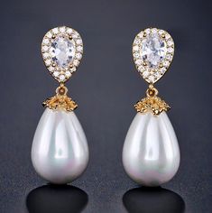 A classy and delicate pair of earrings perfect for the romantic bride, featuring pearls in an iridescent white color and clear cubic zirconia. Electroplated with noble metals (rhodium, 14K rose gold, and 14K yellow gold) for a flawless finish which perfectly enhances the intricate detailing and conveys a modern take on old elegance, these exquisite earrings will add a touch of sophistication to any wedding gown or formal ensemble. Length: 1.25" (approx. 3.2cm); Width: 0.4" (approx. 1cm); Weight: Elegant Diamond White Pearl Earrings For Wedding, Exquisite Pearl Earrings With Cubic Zirconia For Evening, Exquisite Evening Pearl Earrings With Cubic Zirconia, Exquisite Cubic Zirconia Pearl Earrings For Evening, Glamorous Cubic Zirconia Pearl Drop Jewelry, White Pearl Bridal Earrings With Diamond Accents, White Cubic Zirconia Bridal Earrings, Elegant Crystal Bridal Earrings With Pearl Drop, Elegant Bridal Earrings In Diamond White For Formal Occasions