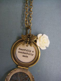 Small locket necklace features a lovely ivory resin rose and bronze butterfly dangle. It opens to the words, 'fearfully and wonderfully made' in vintage typewriter font and professionally sealed inside-- The filigree brass locket measures 27mm and hangs on a brass chain. You may choose your desired length at checkout. It will arrive beautifully packaged, ready for gifting. Not intended for water submersion. Vintage Personalized Charm Necklace For Keepsake, Vintage Locket Charm Necklace For Mother's Day, Vintage Personalized Medallion Charm Necklace, Personalized Vintage Medallion Charm Necklace, Vintage White Charm Necklaces, Vintage Personalized Charm Necklaces As Gift, Personalized Vintage Charm Necklaces As Gift, Personalized Vintage Charm Necklaces For Gift, Vintage Locket Charm Necklace For Gifts