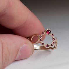 Luxurious Gold Ring set with Beautiful Red Garnets from India. Hand crafted then Set with 10 Cabochon Red Garnets in 3 different Sizes. Truly Excellent ring made in a unique style like no other. The Shank is made of designer Gold Hoops that are becoming smaller and smaller towards the back. All ring sizes available, Other gemstones Available upon request. This ring is 1.3-1.7mm thick depending where you measure and 13,5mm wide at the widest point at the front. Questions are welcome and are answe Red Garnet Stackable Rings As A Gift, Red Stackable Open Rings For Anniversary, Red Garnet Stackable Jewelry, Red Stackable Rings With Bezel Setting As Gift, Unique Red Ring For Anniversary, Unique Round Red Ruby Ring, Modern Red Garnet Rings, Fine Jewelry Red Stackable Rings As A Gift, Fine Jewelry Red Stackable Rings Gift