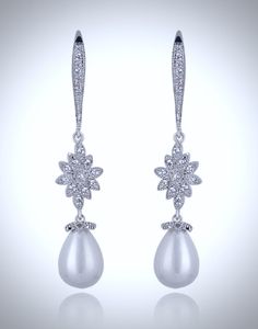 Lightweight and elegant, this beautiful pair of earrings features 12mm teardrop pearls in an iridescent white color accented by clear cubic zirconia for extra sparkle. Overall length of the earring is 50mm (approx. 2"). Hypoallergenic - lead, nickel and cadmium free. This elegant pair of earrings will add glamour to any wedding dress or formal ensemble. White Teardrop Pearl Earrings With Cubic Zirconia, White Cubic Zirconia Teardrop Pearl Earrings, White Pearl Drop Teardrop Earrings With Cubic Zirconia, White Cubic Zirconia Teardrop Earrings With Pearl Drop, Glamorous Teardrop Pearl Earrings For Formal Occasions, Formal White Sparkling Teardrop Earrings, White Teardrop Earrings With Sparkling Stones For Formal Events, White Teardrop Earrings With Sparkling Stones For Formal Occasions, White Sparkling Teardrop Earrings For Formal Occasions