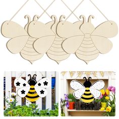 four wooden bees hanging from hooks on a white fence with flowers and potted plants in the background