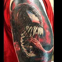 a man's arm with an alien tattoo on it, and the image of a large