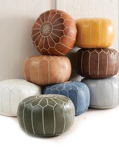 several different colored poufles stacked on top of each other