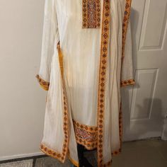 Pakistani Indian Three Piece Formal Dress. Shirt And Dupata Have Beautiful Patch Work Embroidery . Size Approximately Shoulder 15”Bust 22”Waist 19.5”Hip 22”Arm 22.5”Length 38”Shalwar Length 38”Fabric Is Crinkle Chiffon. Condition Is Pre-Owned. Festive White Tunic Set, White Blouse With Dupatta For Eid, Long Sleeve Chanderi Salwar Kameez, Anarkali Tunic Set With Floral Embroidery, Anarkali Set With Floral Embroidery Tunic, Embroidered Chanderi Cream Dress, Cream Embroidered Chanderi Dress, Embroidered Cream Chanderi Dress, Cream Long Sleeve Salwar Kameez For Navratri