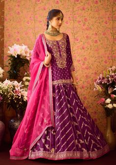 Step into refined elegance with the phlox purple hand-embroidered silk brocade kurta, beautifully paired with a multi-panel brocade lehenga. This stunning ensemble features intricate embroidery that elevates the luxurious fabric, while the lehenga offers graceful movement and flair. Complemented by an embroidered dupatta, this outfit is perfect for festive occasions and celebrations, showcasing a harmonious blend of tradition and style. Purple Chanderi Anarkali Set For Reception, Designer Purple Chanderi Palazzo Set, Traditional Drape Purple Palazzo Set With Dabka Work, Purple Silk Bollywood Palazzo Set, Purple Anarkali Palazzo Set In Chanderi, Purple Chanderi Sharara For Reception, Purple Silk Sharara For Navratri, Purple Anarkali Chanderi Palazzo Set, Anarkali Purple Palazzo Set With Dabka Work