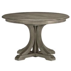 an image of a round dining table with two leaves on the top and one leaf at the base