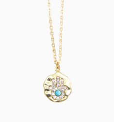 Our Hamsa symbol necklace is a powerful talisman to protect against evil and bring good fortune. This talisman has been around for centuries and is believed to protect against evil and bring good luck. The five fingers of the Hamsa hand represent the five elements, creating a symbol of balance and harmony that's perfect for anyone who values positivity and spirituality.
Length: 18" gold filled chainPendant size: 15mm gold plated charm Symbolic Good Luck Coin Pendant Necklace, Blessing Amulet Necklace With Coin Pendant, Blessing Amulet Style Necklace With Coin Pendant, Good Luck Amulet Necklace With Coin Pendant, Amulet Style Pendant Necklace With Charms, Good Luck Medallion Necklace With Coin Pendant, Spiritual Good Luck Coin Pendant Jewelry, Symbolic Pendant Necklaces With Charms, Amulet Necklace With Adjustable Chain And Round Pendant