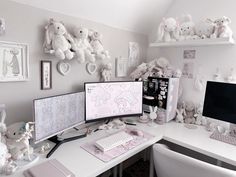 a white desk topped with two computer monitors