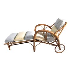 a chaise lounge chair with wheels and cushions on the back is made out of bamboo