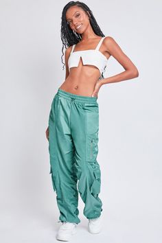 It’s giving off-duty vibes! Our Women's High-Rise Rouched Nylon Jogger is the perfect baggy pant to add to your wardrobe! Designed with an adjustable bungee cord at the elasticized waistband for the perfect fit and comfort. These high waisted pants are meant to be oversized with a baggy and slouchy fit. Featuring silver hardware and large cargo pockets for a sporty-chic vibe. We’ve also added adjustable bungee cords at the bottom hems to give you the option of wearing them more scrunched up at the ankle. Pair these with a crop top and sneakers for a sporty look, or pair with a corset top and combat boots for an edgier feel. Product Details - High-Rise - Elasticized Waistband with Bungee- Single Zip Close Pocket at Thigh- 2 Flap Cargo Pockets at Lower Side - Baggy Fit - Drawstring Hems Size Female References, Bungee Cords, Ymi Jeans, All Jeans, Bungee Cord, Feeling Confident, Cargo Joggers, Baggy Pant, Summer Blue