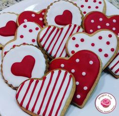 heart shaped cookies on a plate with red and white stripes