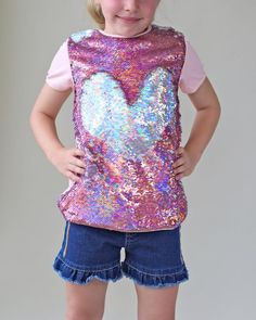 This fun, reversible sequined shirt is your fashion girls staple for the spring or summer! The cotton back provides breathable comfort, while the colorful reverse side is sequined flippin' fun!Front: 100% polyesterBack: 100% cottonHand wash; hang dry Spring T-shirt With Sequins And Short Sleeves, Summer Tops With Contrast Sequin And Stretch, Summer Contrast Sequin Stretch Top, Stretch Summer Tops With Contrast Sequin, Playful Spring Party Tops, Cute Multicolor Party Tops, Playful Summer Party Tops, Playful Pink Stretch Top, Summer Sequined Cotton Tops