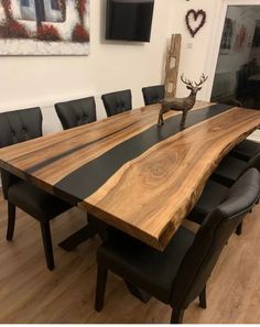 a large wooden table with black leather chairs