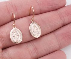 Dainty Oval Virgin Mary earrings in sterling silver, 14K gold filled and rose gold filled. Perfect for a Easter gift! Super dainty and wonderful for everyday wear! EARRING DESCRIPTION: - Oval Virgin Mary charm 14mm - sterling silver, gold filled and rose gold filled - Ear wires in sterling silver, gold filled and rose gold filled - Comes with plastic ear backs for a secure fit - Handmade and packaged beautifully for you! - - - - - - - - - - - - - - - - - - - - MATERIALS: - 14K Gold Filled: Gold Oval 14k Gold-filled Jewelry For Anniversary, Tarnish Resistant Sterling Silver Oval Earrings, Nickel Free Gold Oval Earrings, Nickel-free Gold Oval Earrings, Dainty Oval Rose Gold Jewelry, Dainty Rose Gold Oval Jewelry, Rose Gold 14k Gold Earrings As Gift, Rose Gold 14k Gold Earrings For Gifts, Hallmarked Oval Rose Gold Earrings