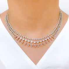 Elevate your look with our Chic Rose Gold Diamond Necklace Set. Crafted from 18k rose and white gold, this set features round diamonds weighing 9.97 carats with F-G color and VS clarity. The necklace measures 17.25 inches and the matching earrings are included, measuring 1.9 inches. The set has a hook lock with adjustable links and screw back earrings. The item weight is 59.0 grams. PRODUCT DETAILS Gold Purity(karat): 18k Item Weight(grams): 59.0 Item Finish: Rose + White Gold Stone: Diamond Dia Exquisite Rose Gold Diamond Cut Necklace, Traditional Yellow Gold Diamond Necklace With Hand-set Diamonds, Gold-tone Diamond Necklaces For Gifts, Gold-tone Diamond Necklace For Gift, Exquisite Hand-set Yellow Gold Diamond Necklace, Rose Gold Diamond Necklace, Gold Chic, 18k Gold Necklace, Diamond Necklace Set