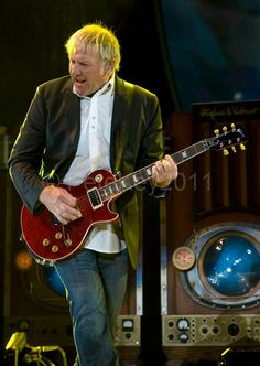 a man playing an electric guitar on stage