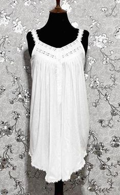 This gorgeous sleeveless Victorian nightgown is made entirely of cotton for the utmost in comfort and softness. It perfectly embodies the beauty and elegance of the Victorian era, embellished with exquisite lace accents. A hint of vintage charm can be added to your evening routine with this dreamy, timeless style created by the lightweight fabric and exquisite lace details. Summer Camisole Nightgown For Night, Sleeveless Summer Night Sleepwear, Elegant Sleeveless Summer Nightgown, Summer Sleeveless Sleepwear, White Summer Cami Nightgown, Casual Summer Nightgown, Elegant Sleeveless Summer Sleepwear, Sleeveless Summer Night Dresses, Summer Night Sleeveless Dresses