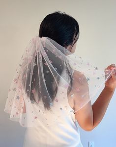 a woman wearing a veil with stars on it