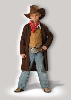 a little boy dressed in a cowboy outfit