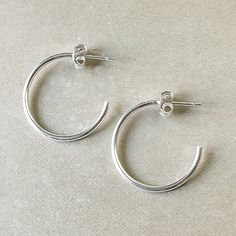 Simple and classic. Lightweight, dainty hoops to wear anywhere and everywhere. Everyday Trendy Sterling Silver Hoop Earrings, Classic Hoop Huggie Earrings For Everyday, Classic Adjustable Hoop Earrings For Pierced Ears, Classic Adjustable Hoop Earrings, Classic Adjustable Hoop Earrings For Everyday, Simple Small Hoop Everyday Jewelry, Elegant Adjustable Hoop Earrings For Everyday, Simple Sterling Silver Hoop Earrings For Everyday, Adjustable Classic Hoop Earrings