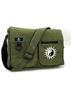 Puzzlestack's Koshi Green Embroidered (Yin Yang embroidery) Laptop Bag is a very flexible bag, which looks equally amazing any way you wear it, shoulder or crossbody! Suitable for working professionals and students. Carry this sporty, yet casual-looking laptop bag anywhere! Having organizational features such as a large spacious main compartment and various pockets. Underneath the velcro flap opening, you will find a large zipper-closed pocket. Within the main compartment, there is another compa Eco-friendly Green Shoulder Bag With Pockets, Embroidered Canvas Rectangular Shoulder Bag, Casual Green Embroidered Shoulder Bag, Eco-friendly Embroidered Shoulder Bag For Daily Use, Eco-friendly Embroidered Shoulder Bag, Green Cotton Bags With Embroidery, Everyday Green Embroidered Bag, Embroidered Green Cotton Bags, Green Embroidered Cotton Bags