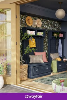 an open door to a living room filled with lots of furniture and flowers on the wall