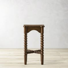 a small wooden chair sitting on top of a hard wood floor