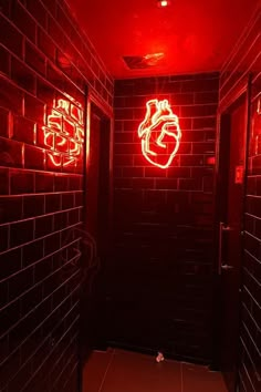 a red light is shining on the wall in a dark room with tiled walls and doors