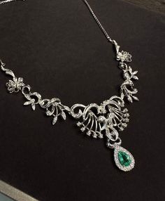 Elegant and exquisite, Victorian style necklace with diamonds in 18Kt white gold in symmetrical floral design, beautifully handcrafted. The center sits a sparkly, enchanting natural Colombian Emerald in pear cut, the emerald is 0.70 ct and has stunning luster, it is surrounded with a halo of natural brilliant white diamonds weight approx 0.2 ct. The necklace is a true beauty, ravishing and gleaming, the floral part was made with 9 hinged section, with millegrain setting details and dainty diamon Opulent Diamond Necklace With 17 Jewels, Exquisite Diamond And Emerald Formal Necklace, Hand-set Emerald Pendant Necklace For Formal Occasions, Luxury Emerald Necklace With Diamond Accents For Formal Events, Exquisite Emerald Necklace For Anniversary, Exquisite Emerald Necklace, Exquisite Diamond Emerald Necklace For Formal Occasions, Exquisite Emerald Necklace With Diamonds For Formal Events, Opulent Diamond Necklace For Formal Events