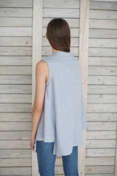 "Loose linen top / Linen blouse with gussets / Linen summer blouse / Sleeveless linen shirt / Linen maternity blouse / Ice blue Comfortable linen cloth hand made from washed linen fabric. The blouse is loose, flare, with two triangular shape insets in sides. You can choose from 16 colors. (The color palette you can find it in the end of listing). Details: - 100% pure Baltic linen; - medium weight linen; - color: ice blue - washed; - simply finished; - handmade; Size: model is wearing size M GENE Sleeveless Linen Vest For Daywear, Spring Linen Beach Vest, Linen Vest For Daywear, Blue Linen Blouse For Vacation, Blue Linen Blouse For Spring, Summer Linen Vest For Layering, Linen Sleeveless Vest For Layering, Spring Blue Linen Blouse, Summer Layering Linen Vest