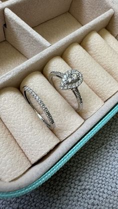 an open jewelry box with three wedding rings in it and one diamond ring on the inside